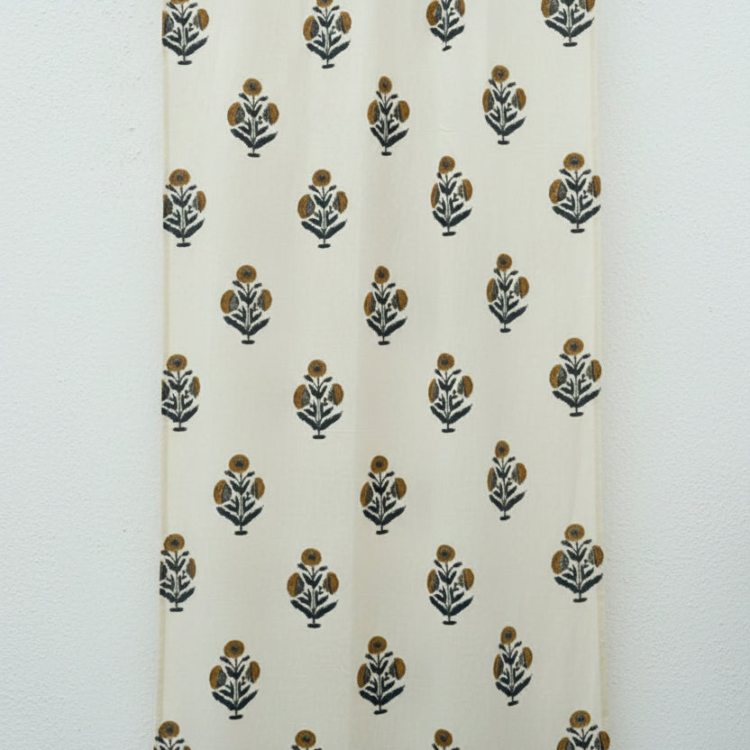 White curtain with black and green floral patterns on a white background