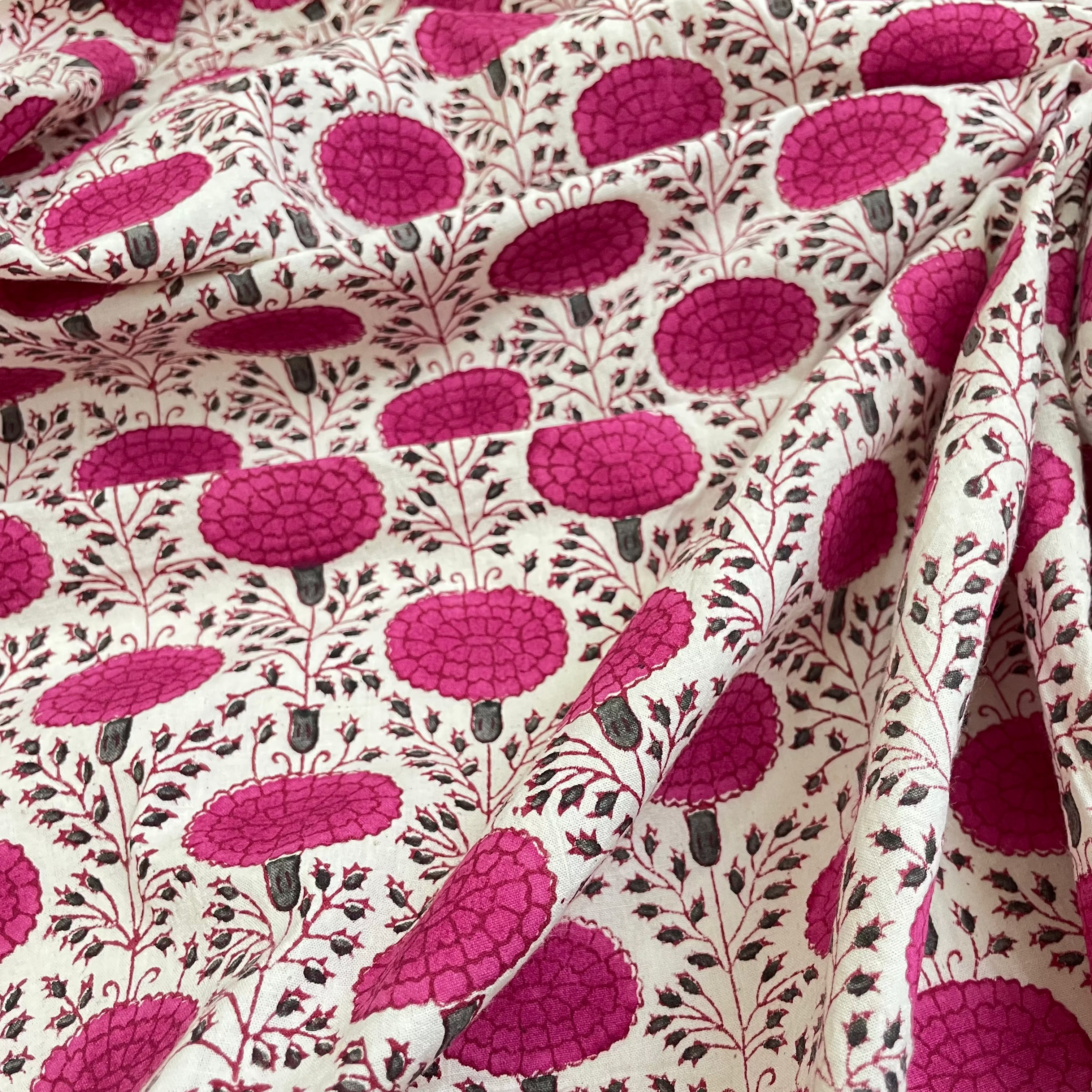 Fabric with a pink floral pattern on a white background