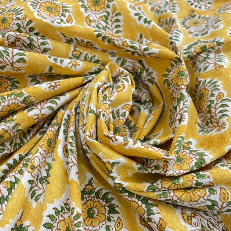 Yellow fabric with green and white floral pattern