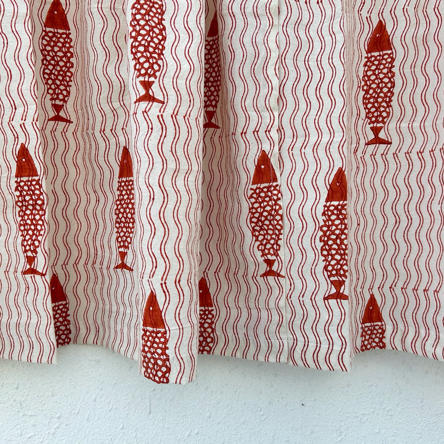 Curtain with red fish pattern on a white background