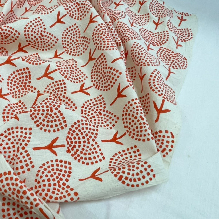 Fabric with orange floral pattern on a white background