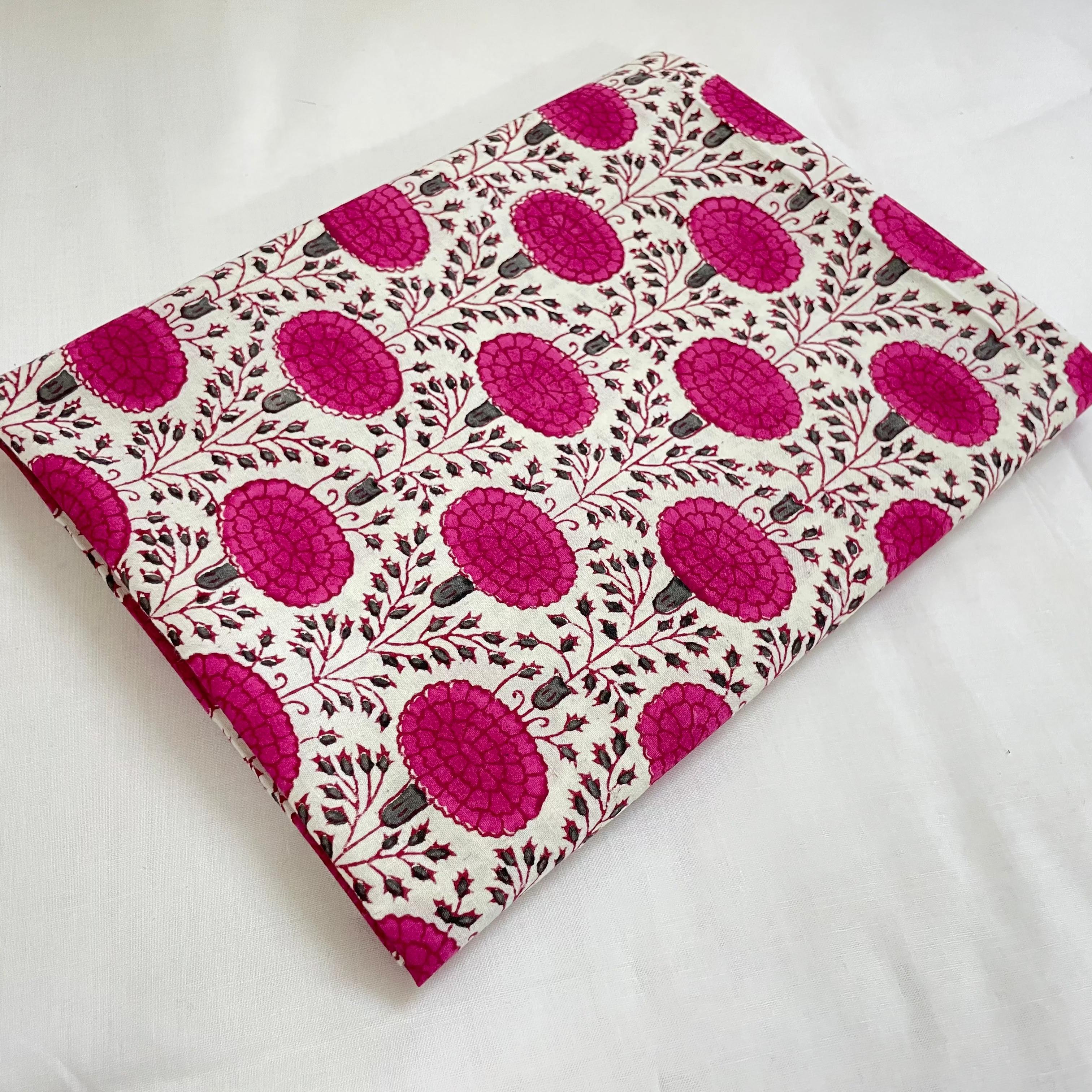 Fabric with pink floral pattern on a white background