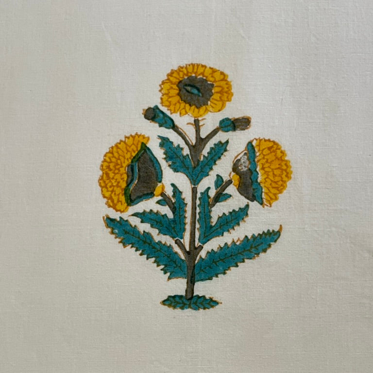 Embroidered design of a flower on a white fabric background