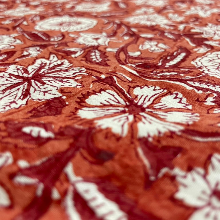 Close-up of a floral patterned fabric with brown and white colors.