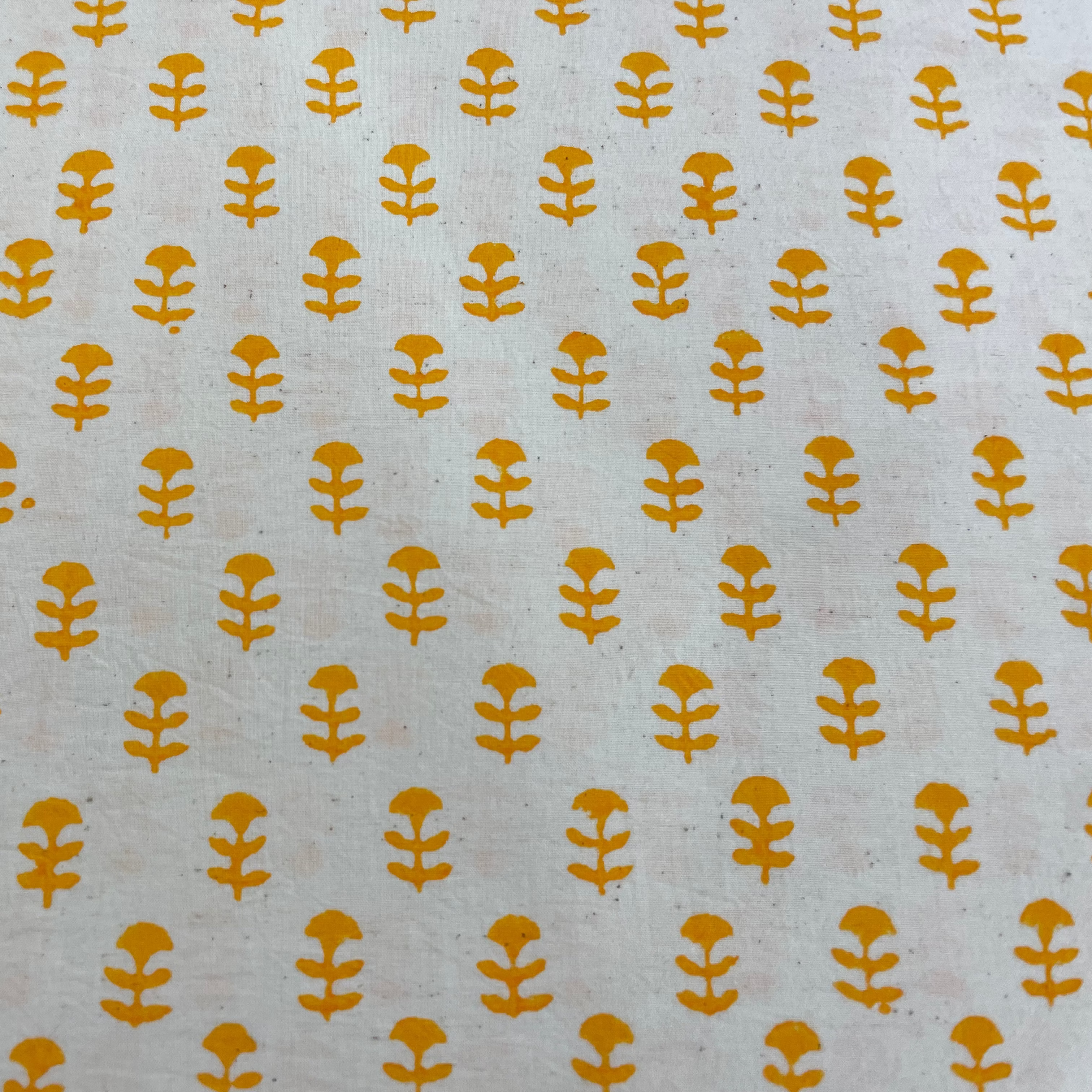 Pattern of yellow floral shapes on a light gray background