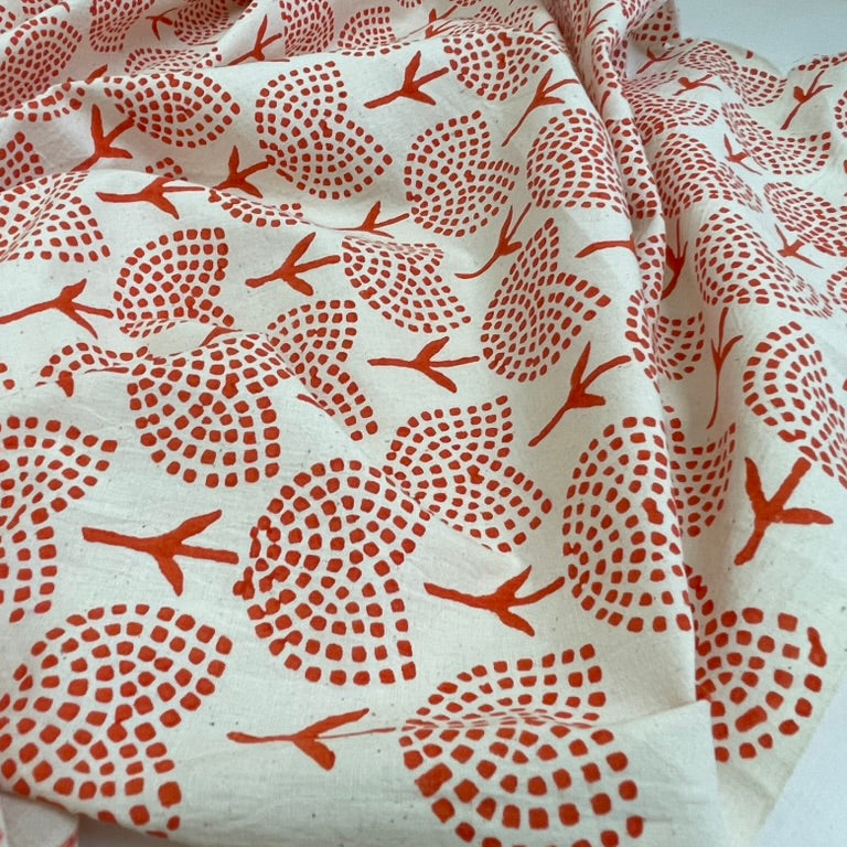 Fabric with red floral pattern on a white background