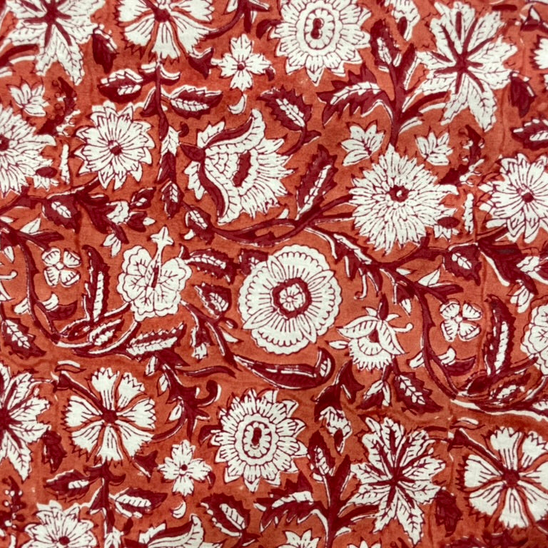 Floral pattern with white flowers on a red-brown background