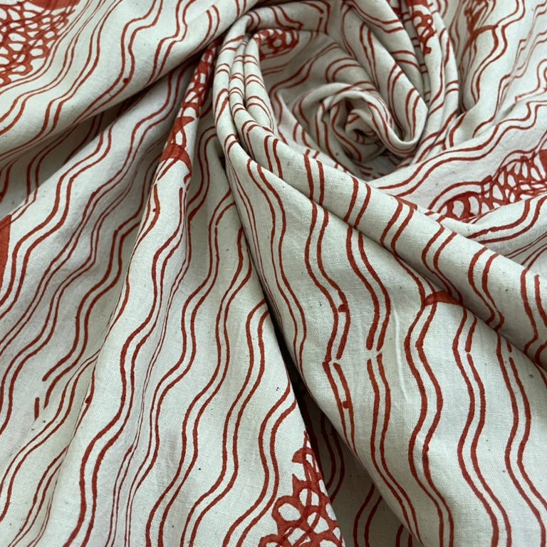 Fabric with red fish and wave pattern on a white background