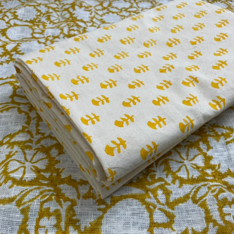 Folded fabric with yellow floral pattern on a textured background