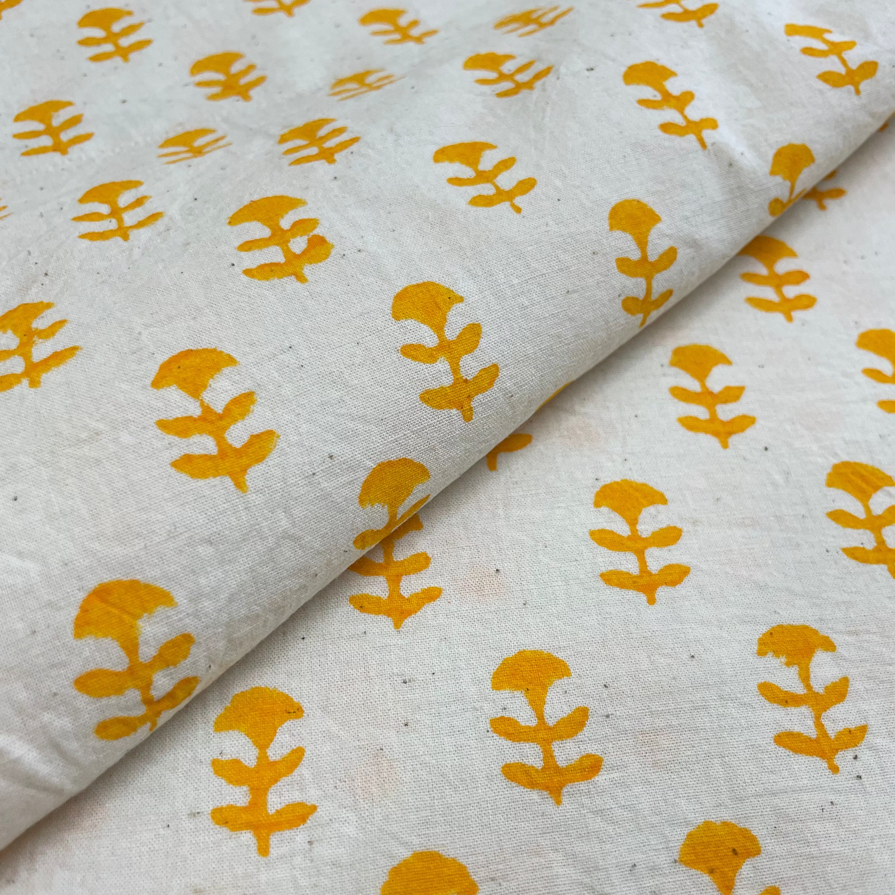 yellow and beige floral print fabric