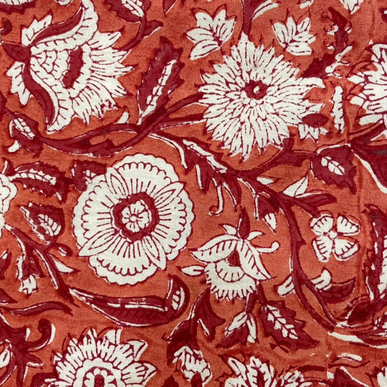 Floral pattern with white flowers on a red-brown background