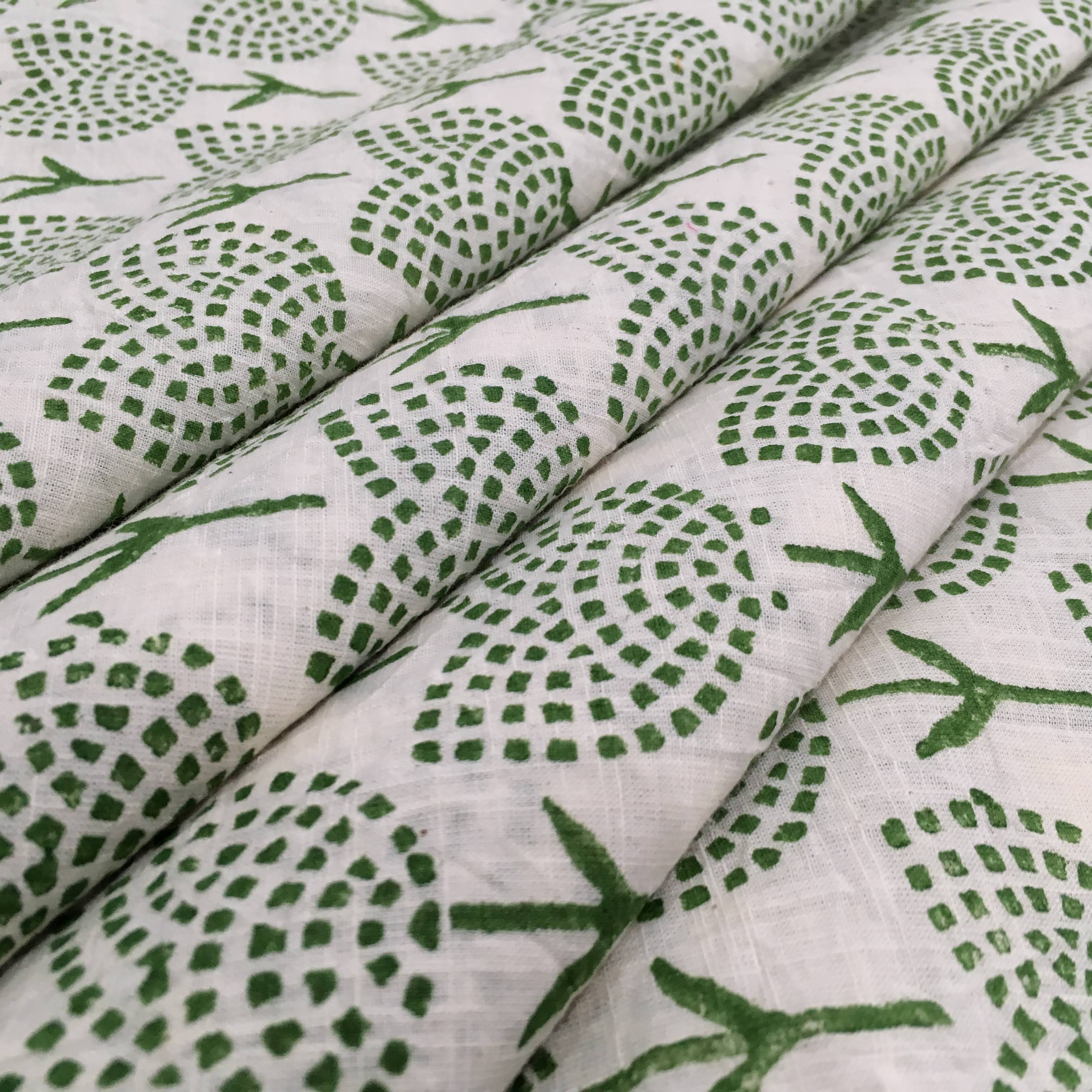 Green leaf pattern on white fabric