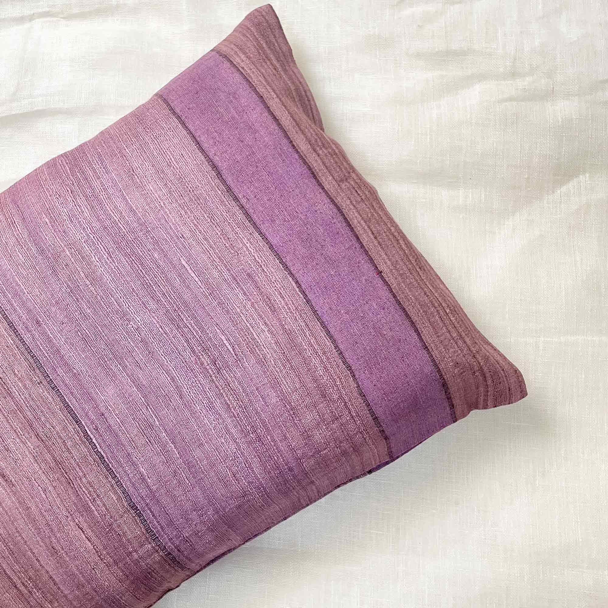 Purple pillow with a textured pattern on a white background