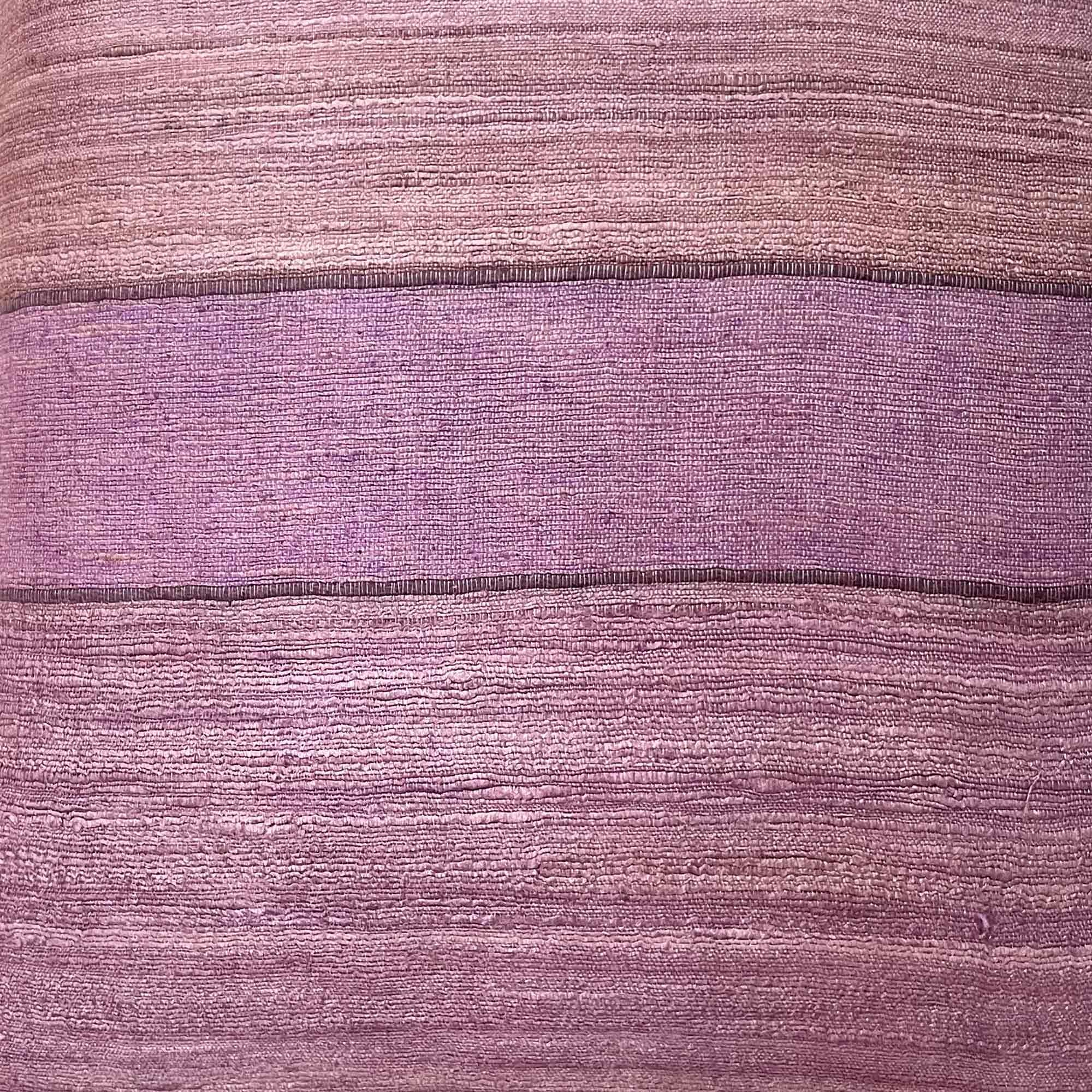 Close-up of a textured purple fabric with horizontal stripes