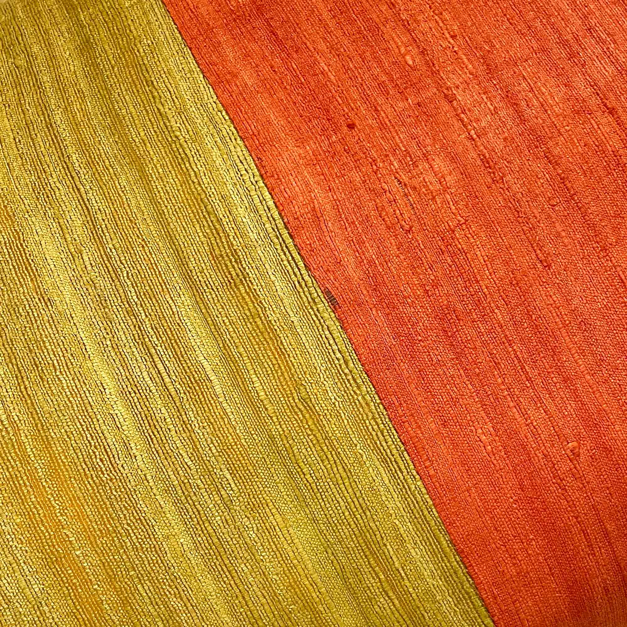 Rust and mustard colorblock tussar silk cushion cover woven by Indian artisans.