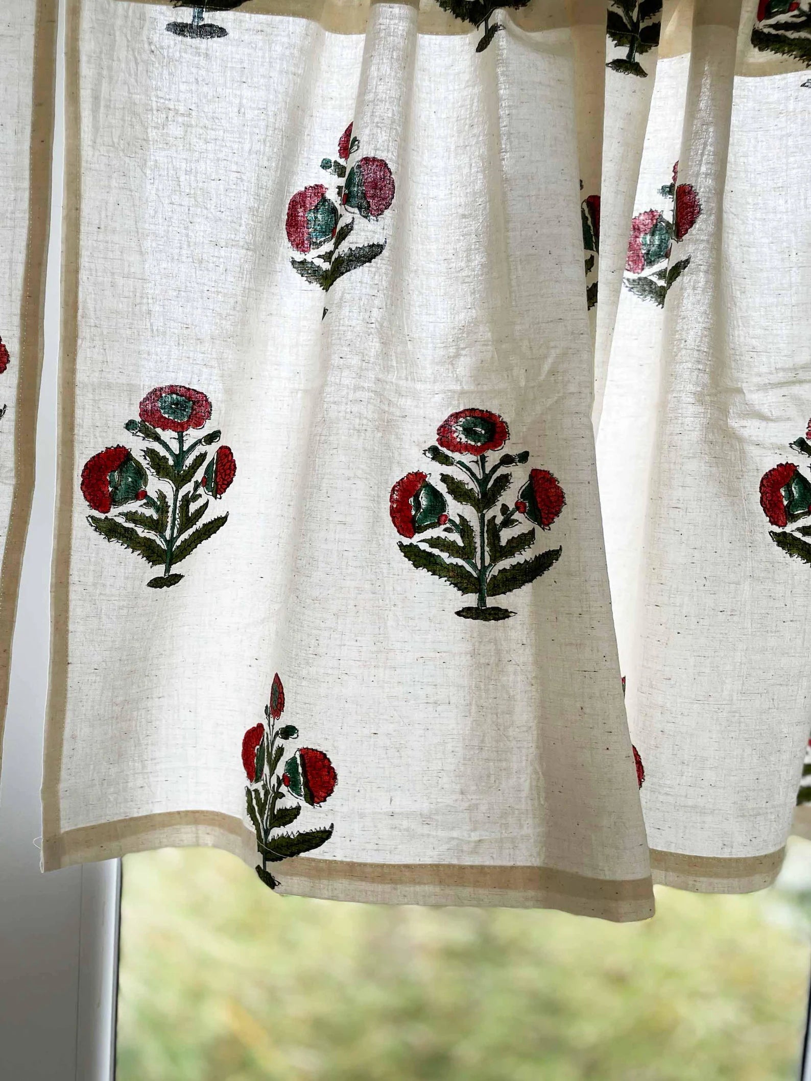 Hand block printed cotton café curtain with rust and green poppy floral pattern for kitchen window.