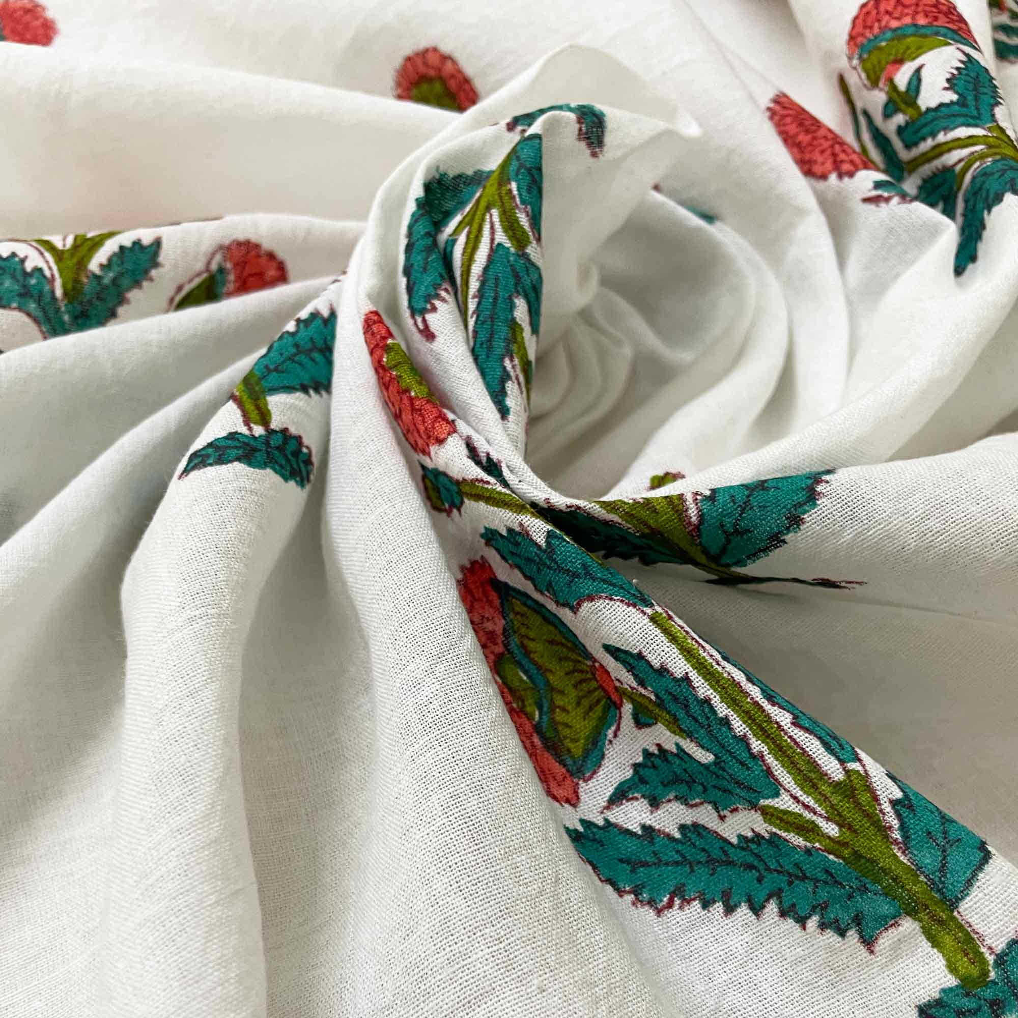 Close-up of white fabric with colorful floral patterns