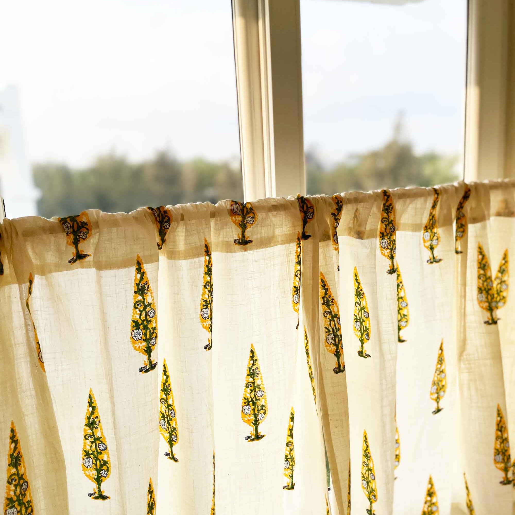 Sheer curtain with tree pattern in front of a window