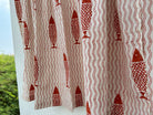 Curtain with red fish and wavy line pattern on a white background