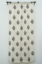 White curtain with black and green floral patterns on a white background