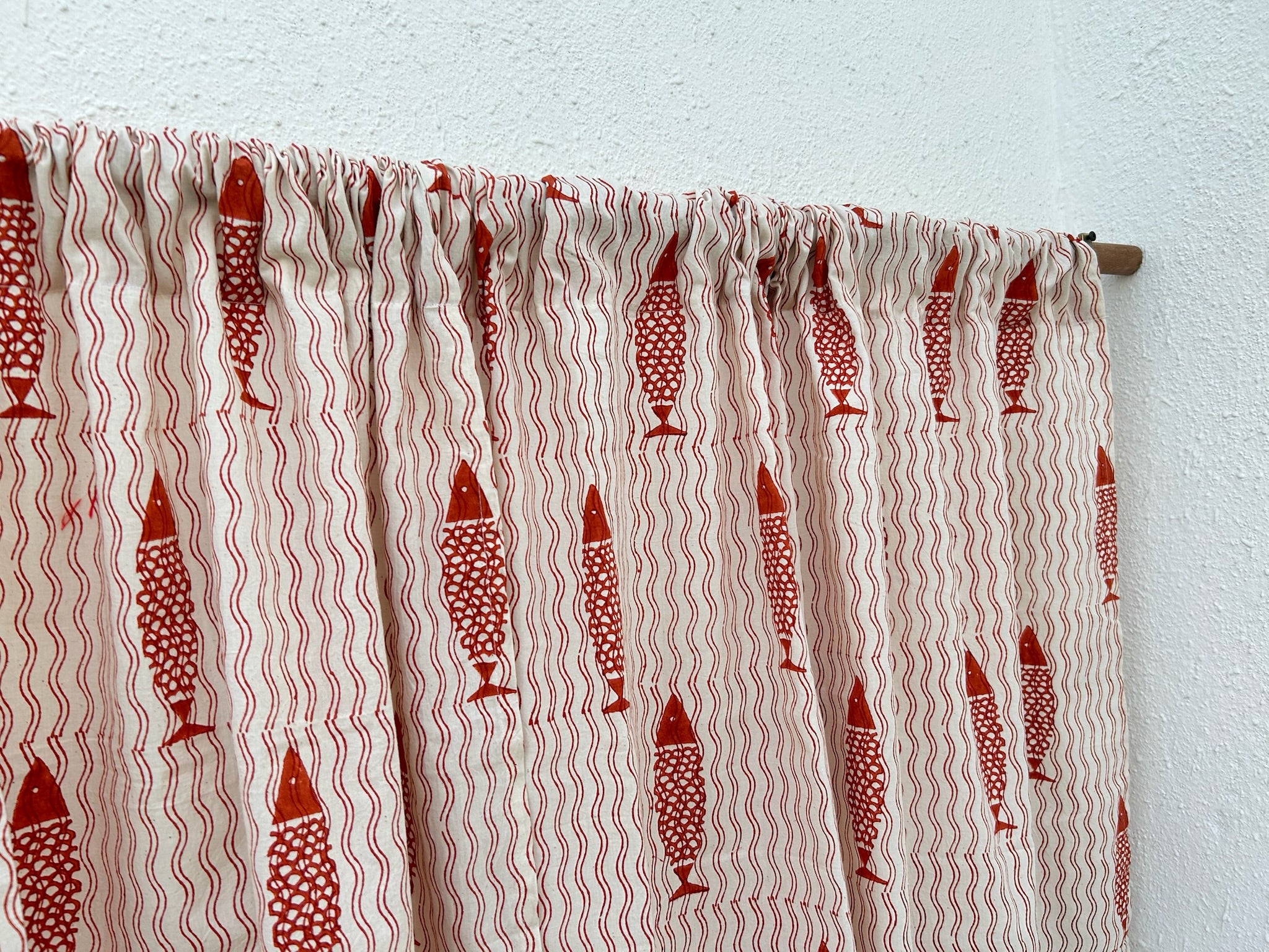 Textile with red fish pattern on a white background