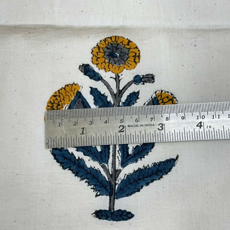 printed floral design on fabric with a ruler for scale.