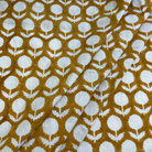 Fabric with white floral pattern on a mustard yellow background
