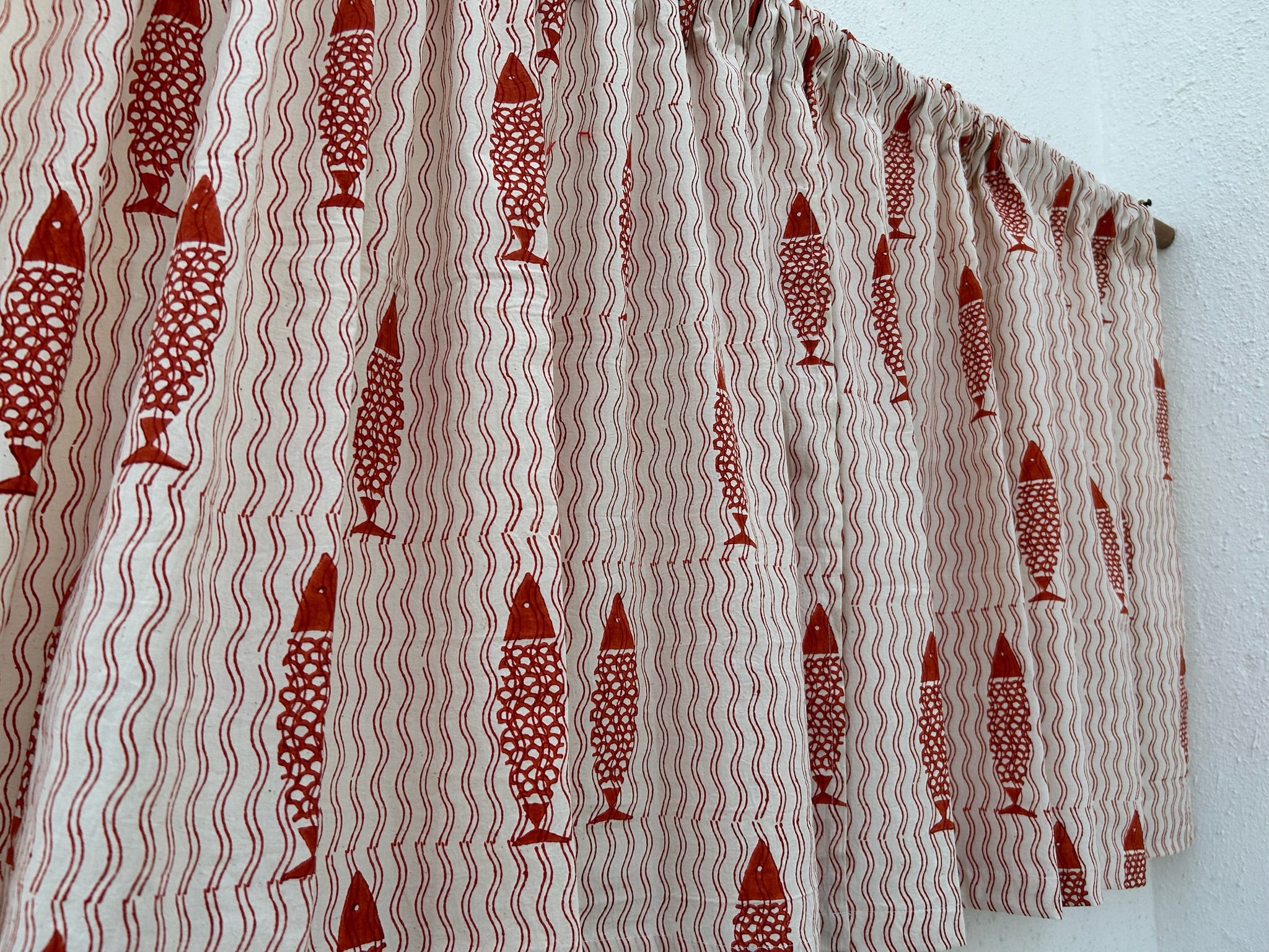 Fabric with red fish pattern on a white background