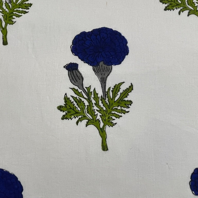 A close-up of a fabric or wallpaper pattern featuring dark blue marigold flowers and green leaves on a white background.