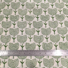 Green tree pattern on beige fabric with a ruler for scale