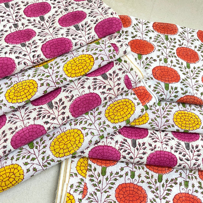 Fabric with a colorful pattern of flowers and leaves on a light background