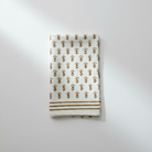 Folded linen napkins with floral pattern on a white background