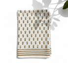 White towel with brown pattern and stripes on a white background