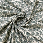 Roll of patterned fabric with geometric design in gray and white