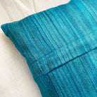 Grey and teal colorblock silk pillow cover with a modern handcrafted look and smooth woven texture.